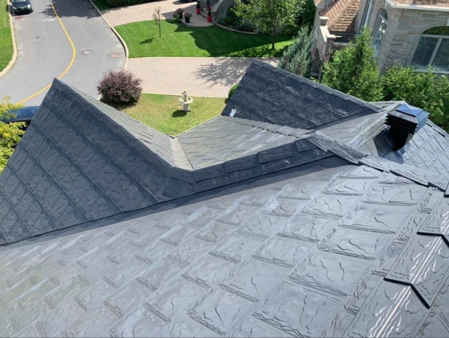 Grey Metstar slate-profile roof with detailed transitions