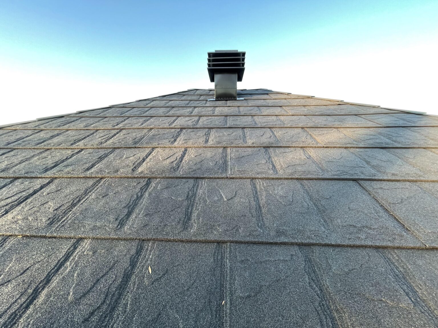 Completed Metstar steel roof showing a slate-inspired surface pattern