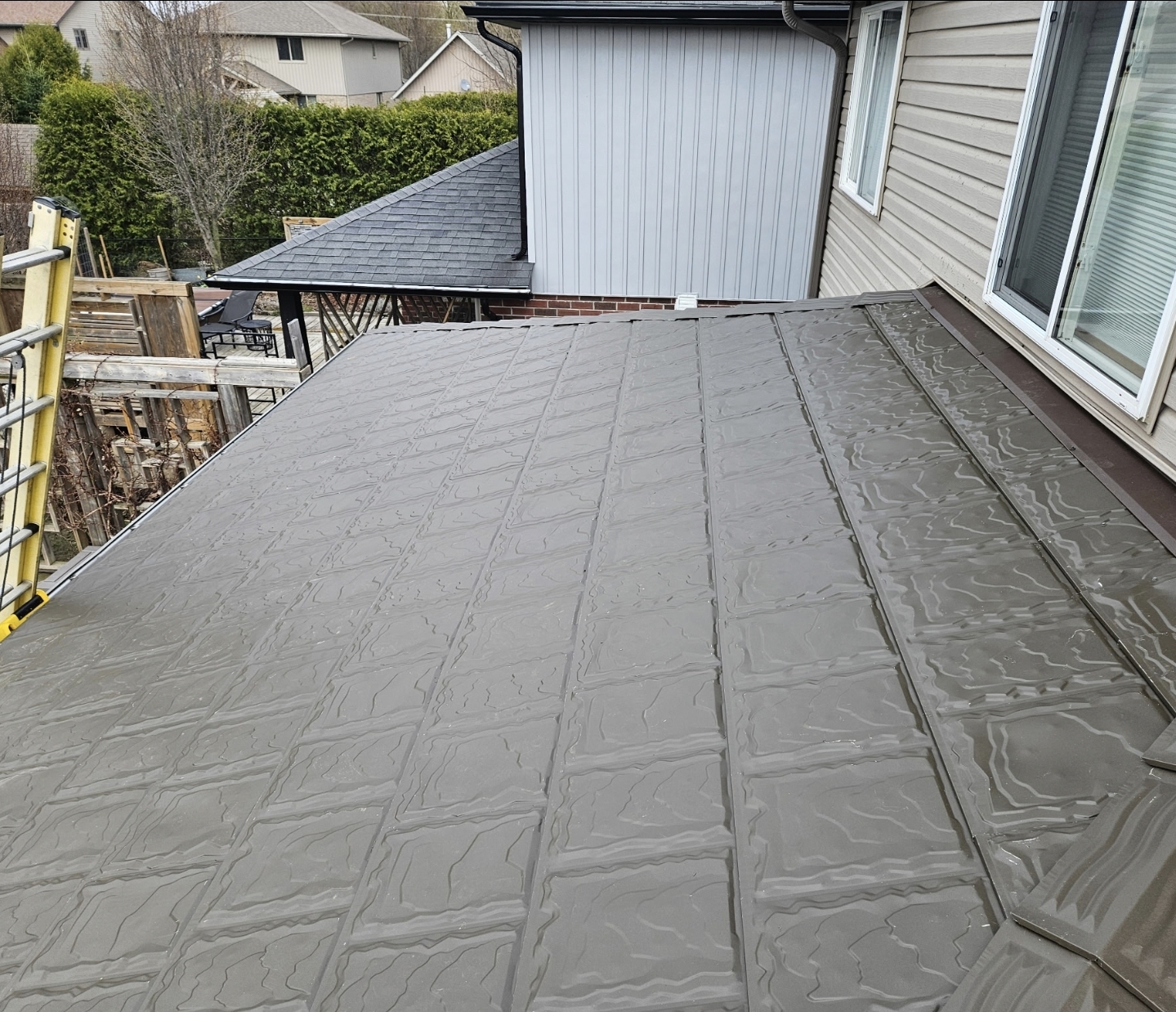 Metstar steel roofing installed beside an exterior wall and roof transition